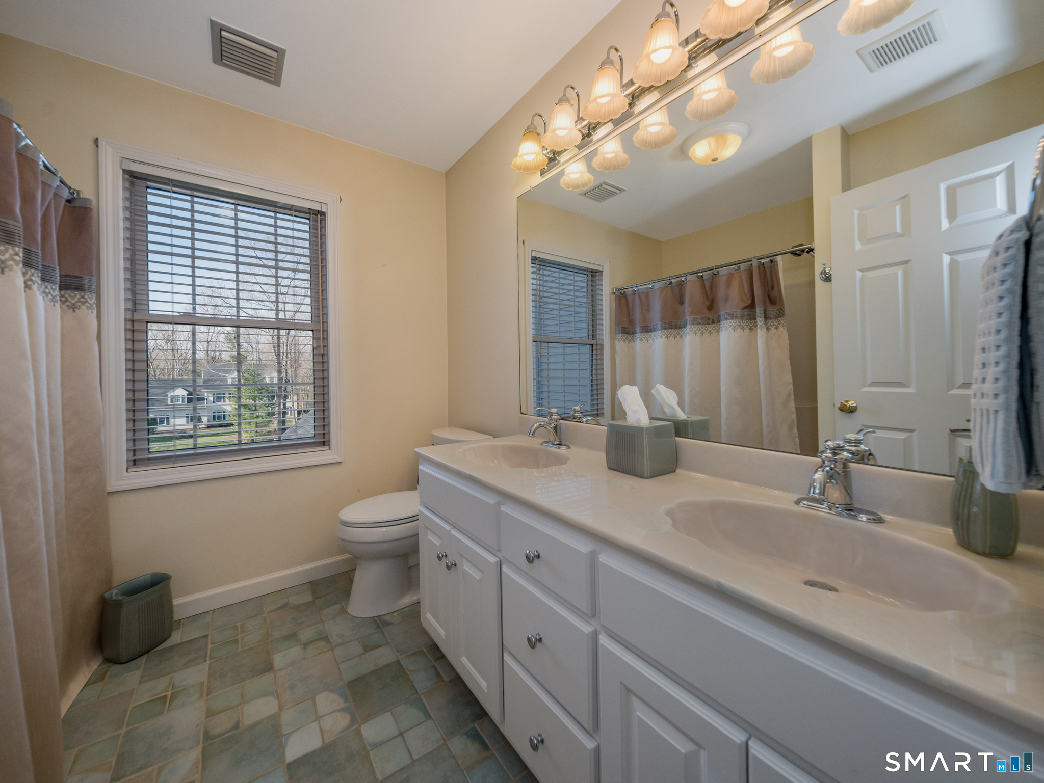 11 Kachina Way Madison, CT 06443 - Photo 30 of 40 a bathroom with a double vanity sink toilet and a mirror