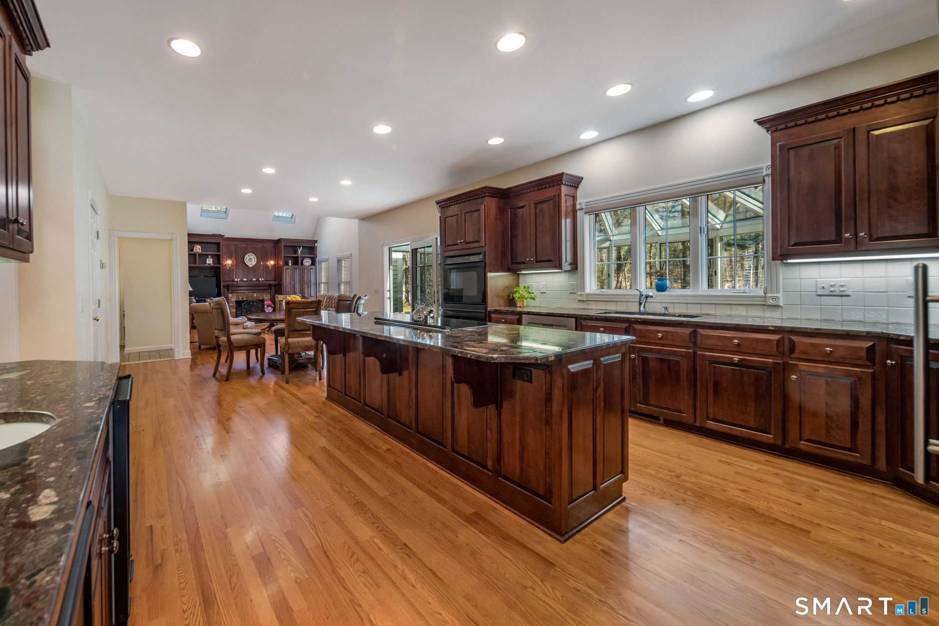 11 Kachina Way Madison, CT 06443 - Photo 10 of 40 a kitchen with stainless steel appliances granite countertop wooden cabinets a sink a stove a refrigerator and island with wooden floors