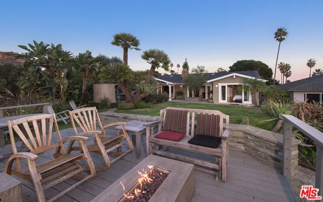 a view of a patio with a chairs and table in the patio