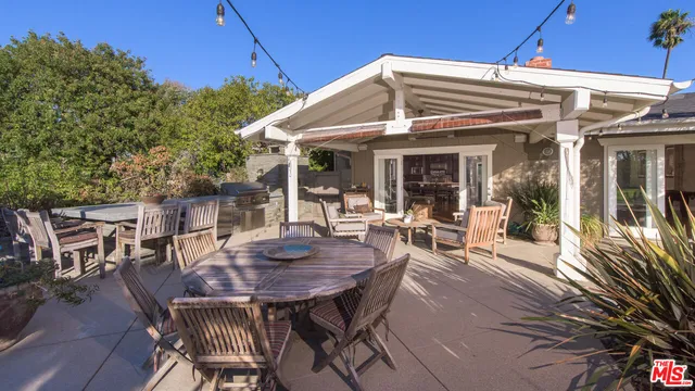 a view of a patio with table and chairs and potted plants