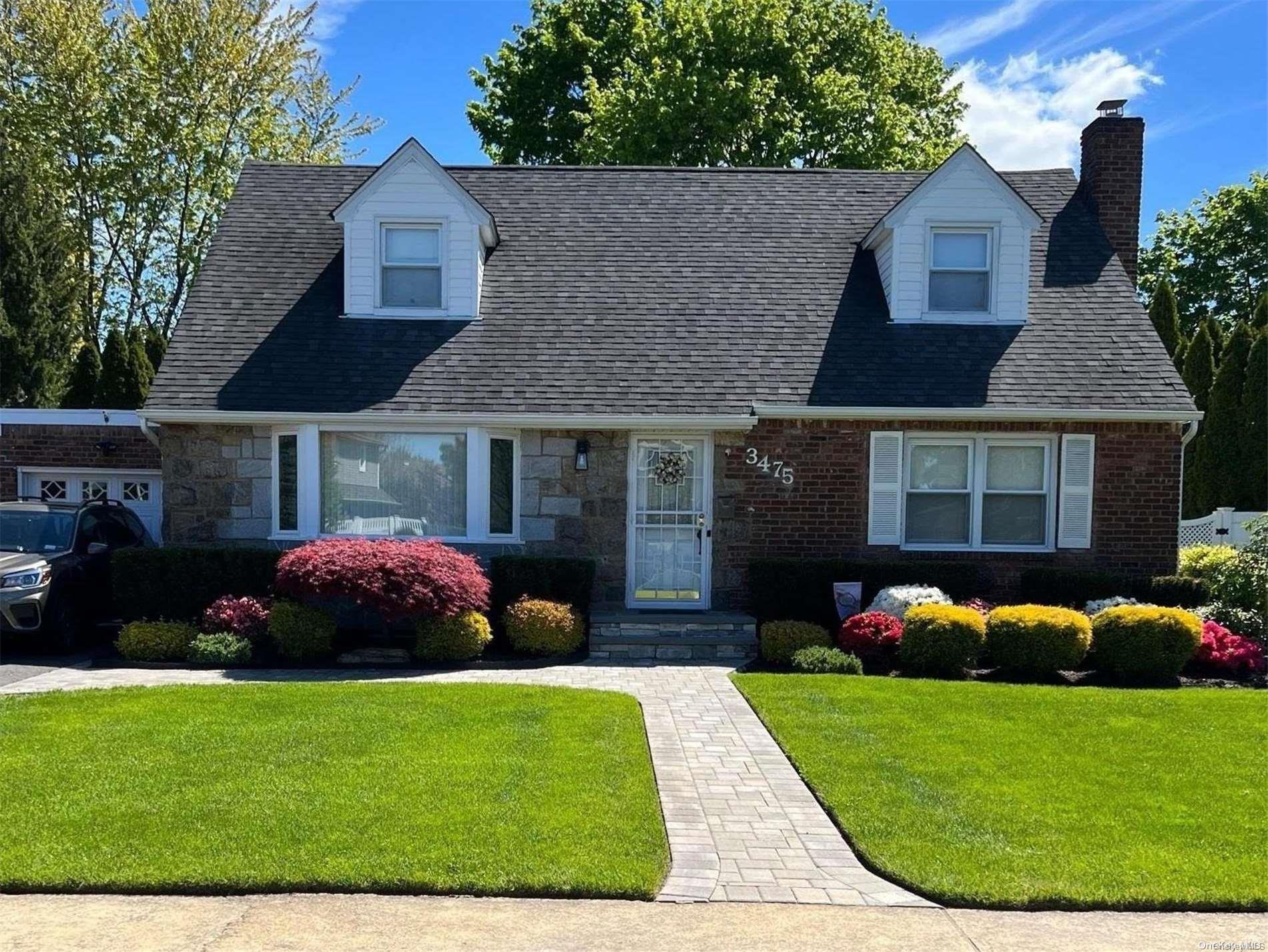 3475 Surele Road Wantagh, NY 11793 - Photo 1 of 1 a front view of a house with a garden and plants