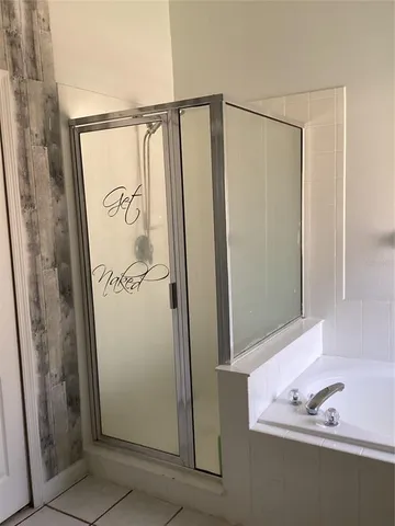 a bathroom with a shower and a sink