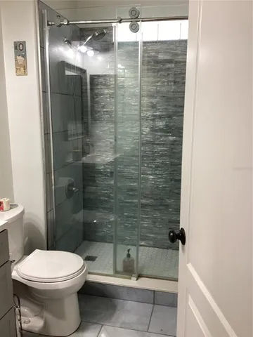 a bathroom with a toilet and shower