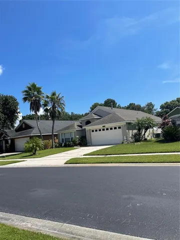 a white house with a yard and plants