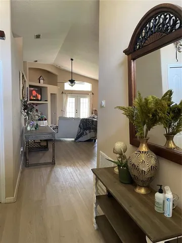 a living room with furniture and wooden floor