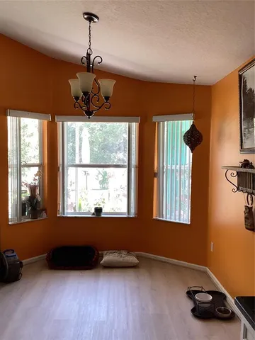 a living room with windows and a wooden floor
