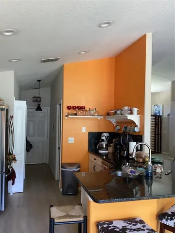 a kitchen with a stove and a refrigerator