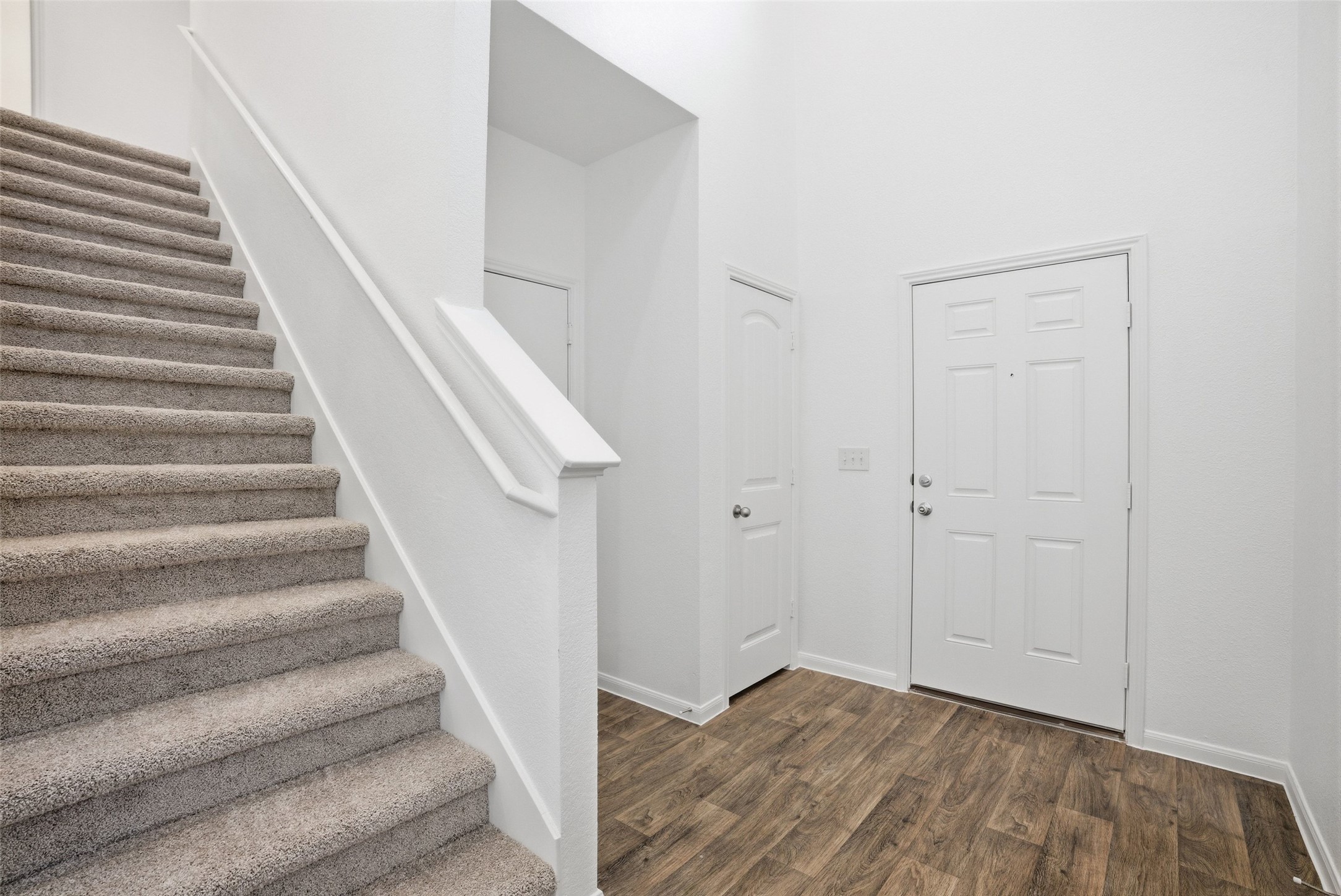 3009 Tilmon Ln. Austin, TX 78725 - Photo 17 of 33 Foyer with stairway and dark wood-style floors