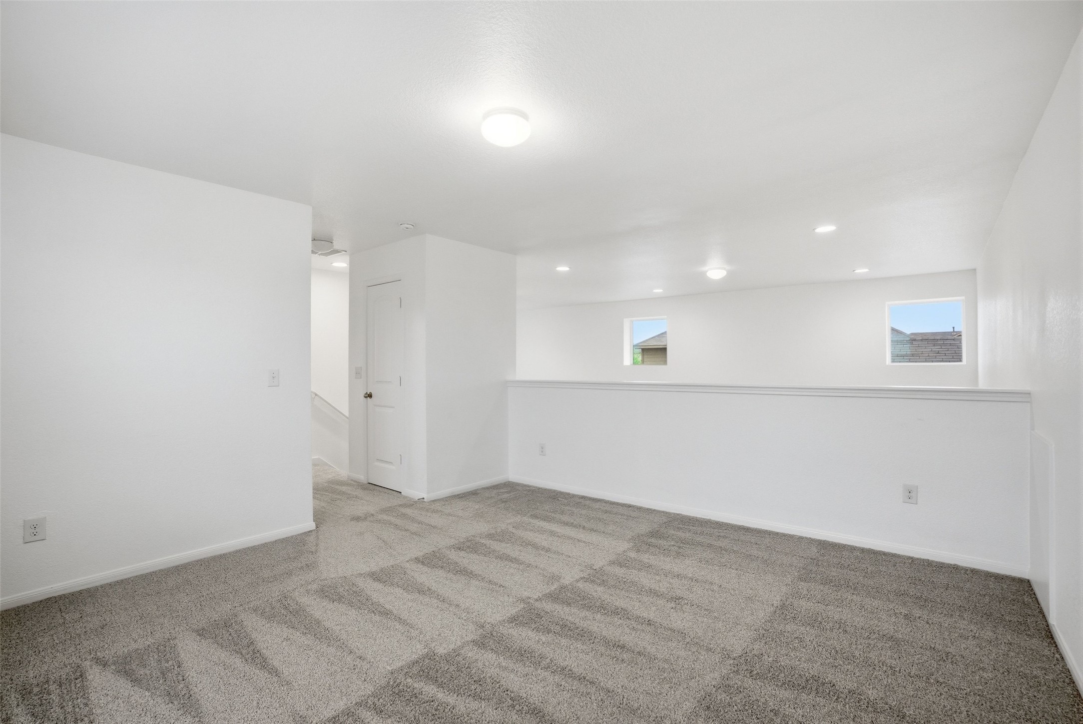 3009 Tilmon Ln. Austin, TX 78725 - Photo 19 of 33 Empty room featuring plenty of natural light, light colored carpet, and recessed lighting
