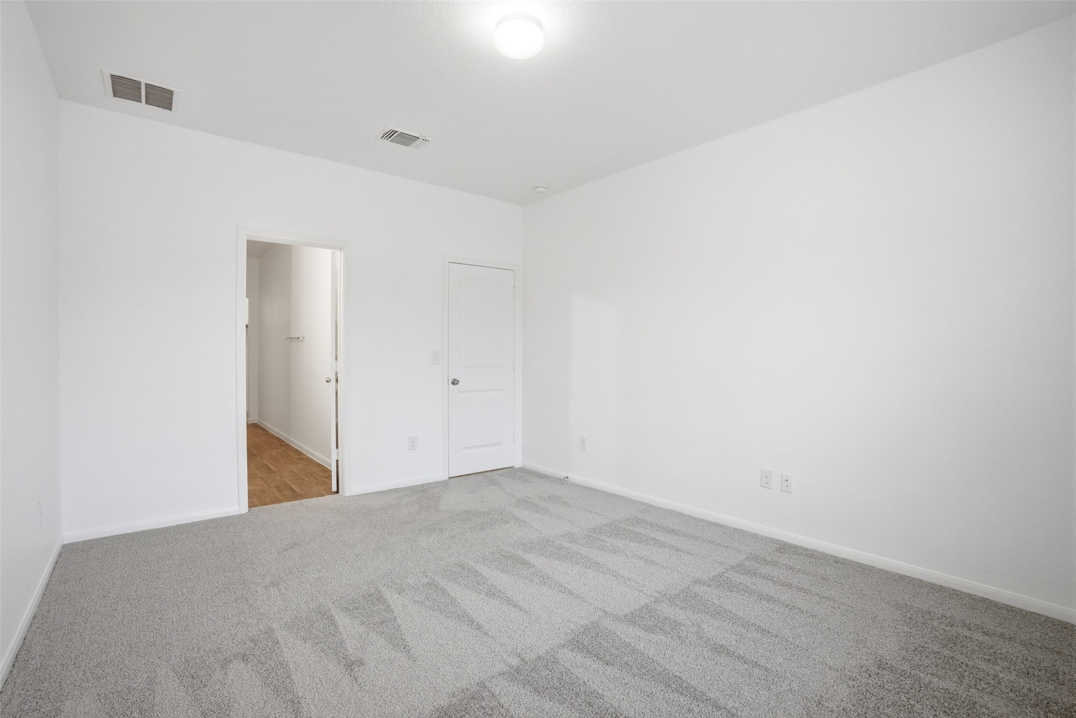 3009 Tilmon Ln. Austin, TX 78725 - Photo 20 of 33 Unfurnished bedroom featuring light colored carpet and baseboards