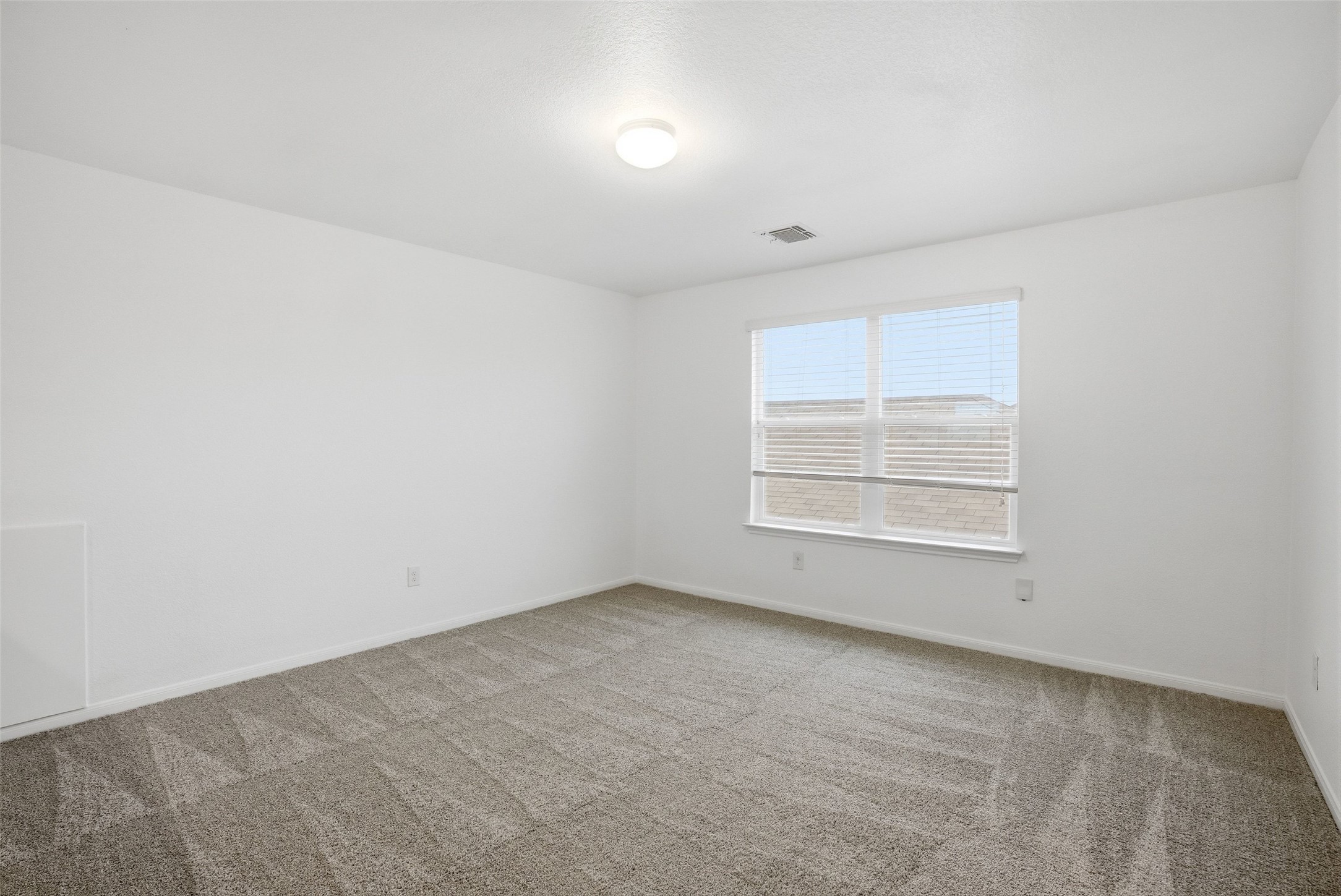 3009 Tilmon Ln. Austin, TX 78725 - Photo 21 of 33 Empty room with light carpet and baseboards