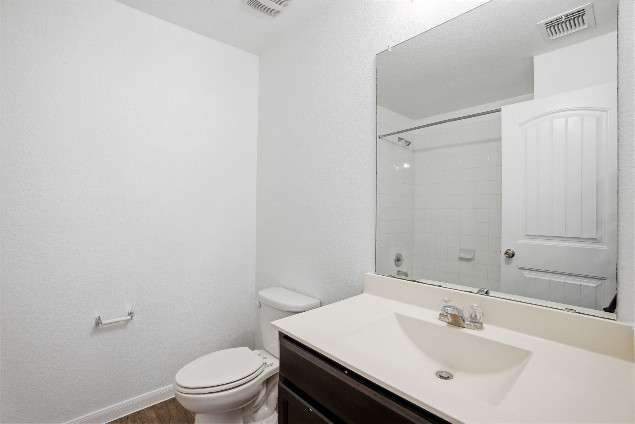 3009 Tilmon Ln. Austin, TX 78725 - Photo 24 of 33 Bathroom featuring vanity, a shower, and dark wood-type flooring