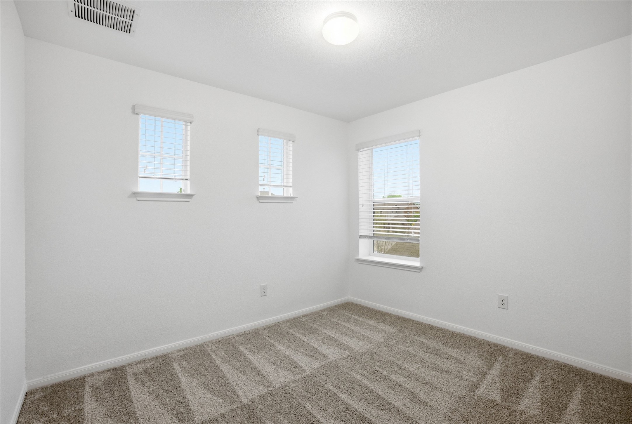 3009 Tilmon Ln. Austin, TX 78725 - Photo 25 of 33 Spare room featuring baseboards and light colored carpet