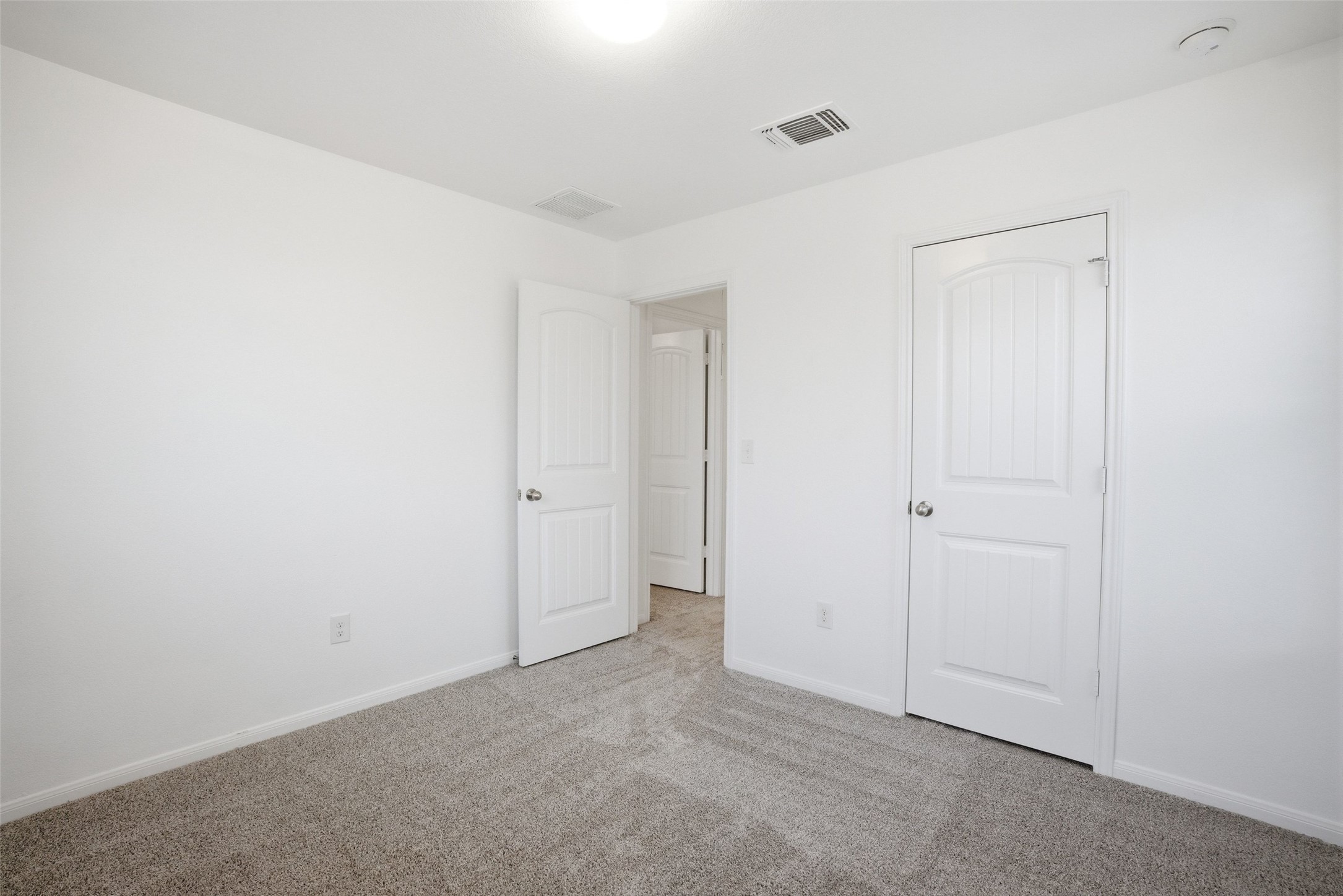 3009 Tilmon Ln. Austin, TX 78725 - Photo 26 of 33 Unfurnished bedroom featuring light colored carpet and baseboards