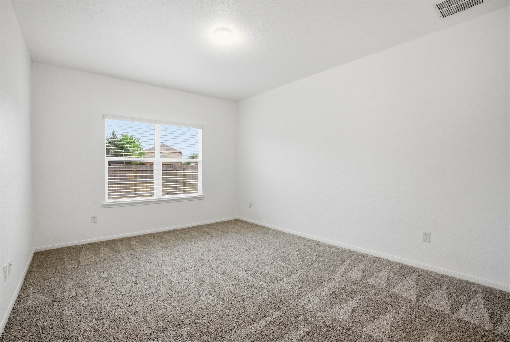 3009 Tilmon Ln. Austin, TX 78725 - Photo 28 of 33 Spare room with light colored carpet and baseboards