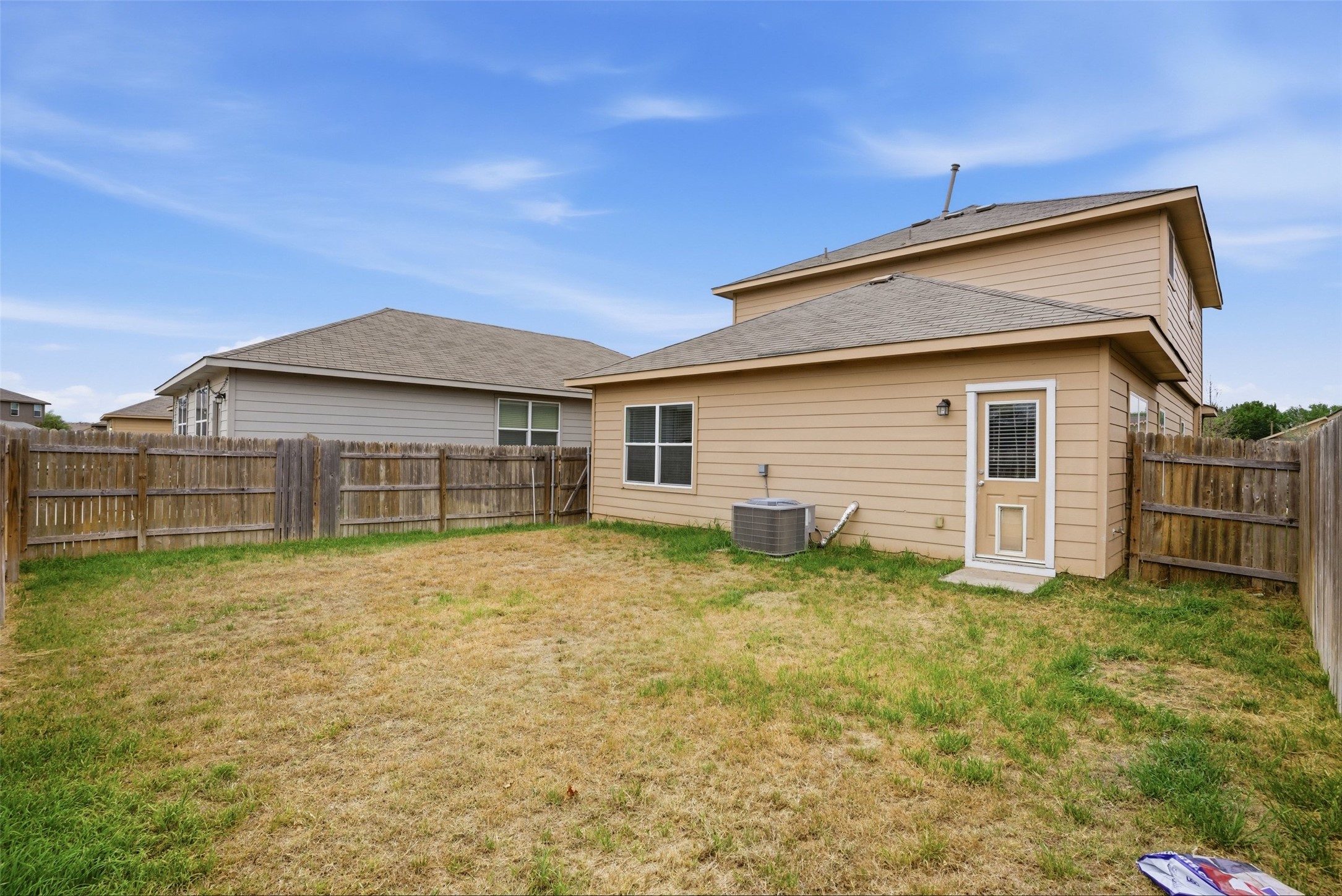 3009 Tilmon Ln. Austin, TX 78725 - Photo 31 of 33 Back of property featuring a fenced backyard