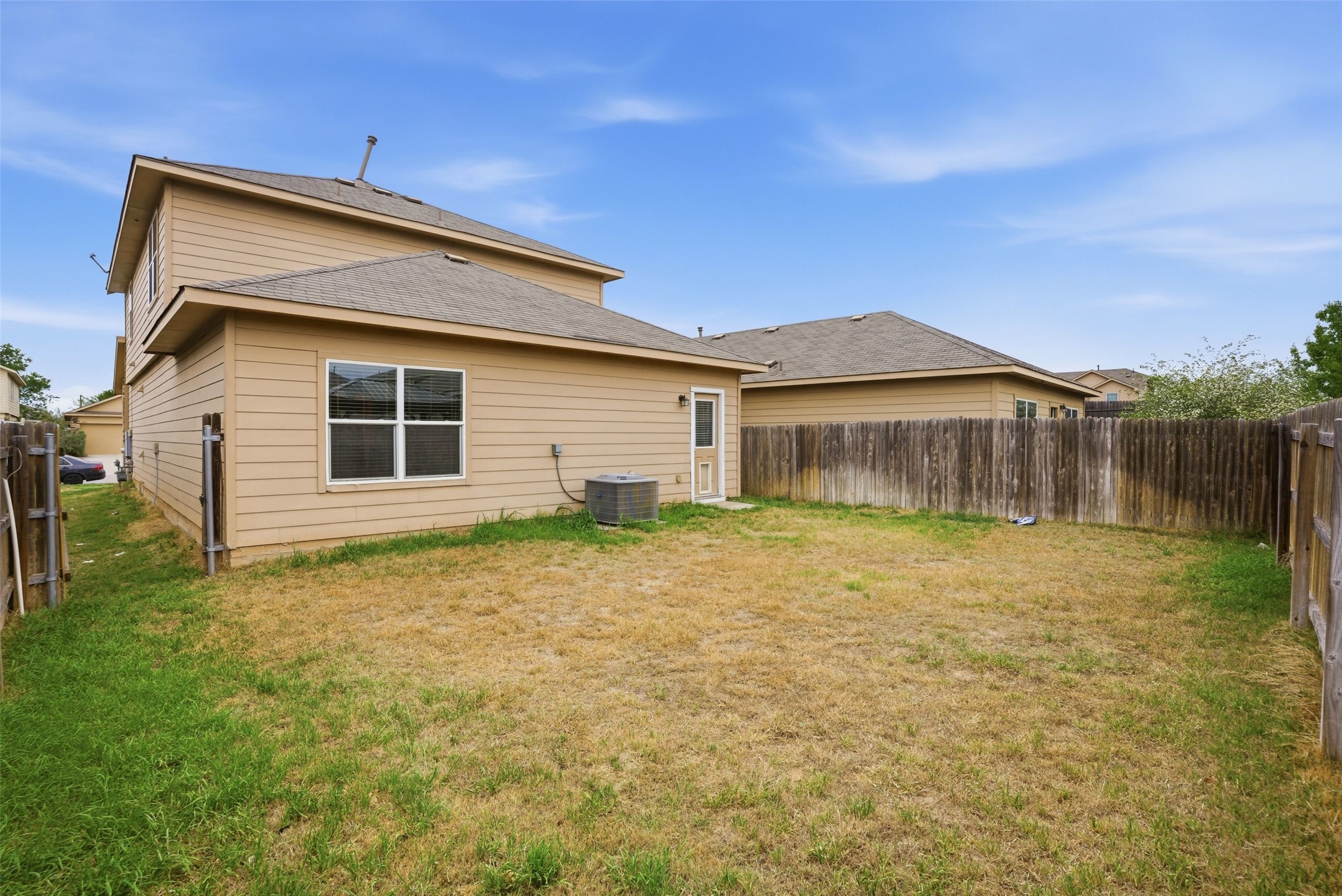 3009 Tilmon Ln. Austin, TX 78725 - Photo 32 of 33 Rear view of house featuring a fenced backyard