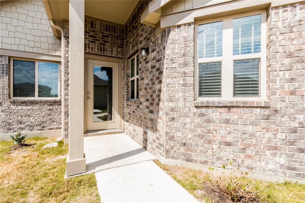 2104 Pindos Pony Way Georgetown, TX 78626 - Photo 4 of 30 A classic brick exterior with a welcoming entryway, ready for personal touches.
