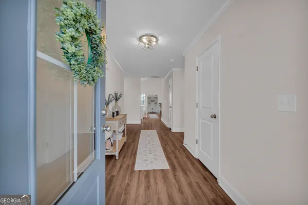 a kitchen with stainless steel appliances granite countertop a sink dishwasher stove top oven and cabinets with wooden floor