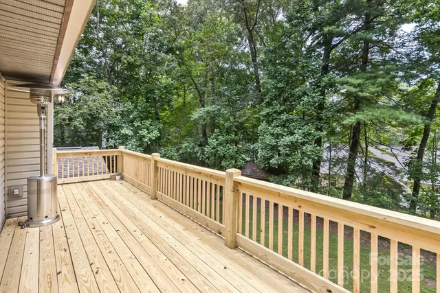 a view of balcony with wooden floor and fence