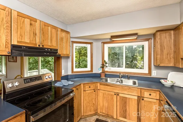 a kitchen with a large window and a sink