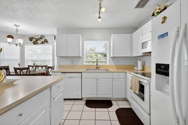 a kitchen with stainless steel appliances a refrigerator and a stove top oven