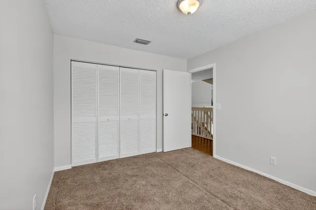 a bedroom with a bed and a television