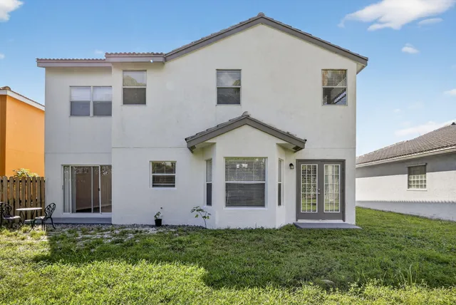 a view of a chair and table in backyard of the house