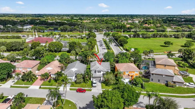 an aerial view of house with yard and swimming pool