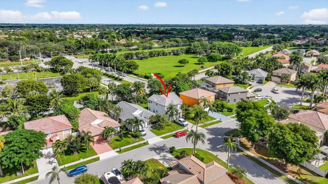an aerial view of a houses with a yard and lake view