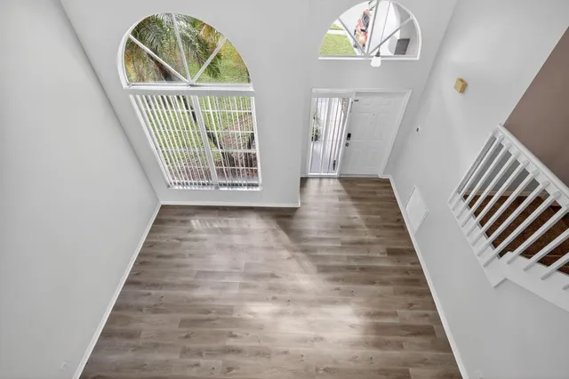 a kitchen with white cabinets and appliances