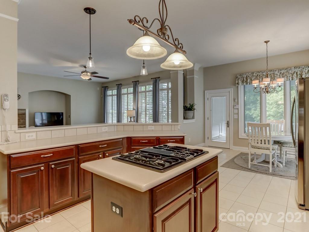 7152 Michael Scott Crossing Fort Mill, SC 29708 - Photo 22 of 48 a kitchen with a stove a sink a chandelier and living room view
