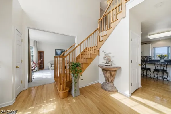 a kitchen with stainless steel appliances kitchen island granite countertop a table chairs and a refrigerator