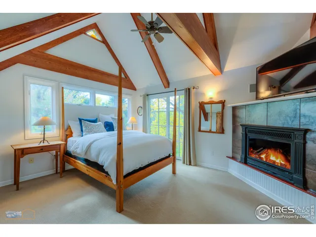 a bedroom with a bed and a fireplace