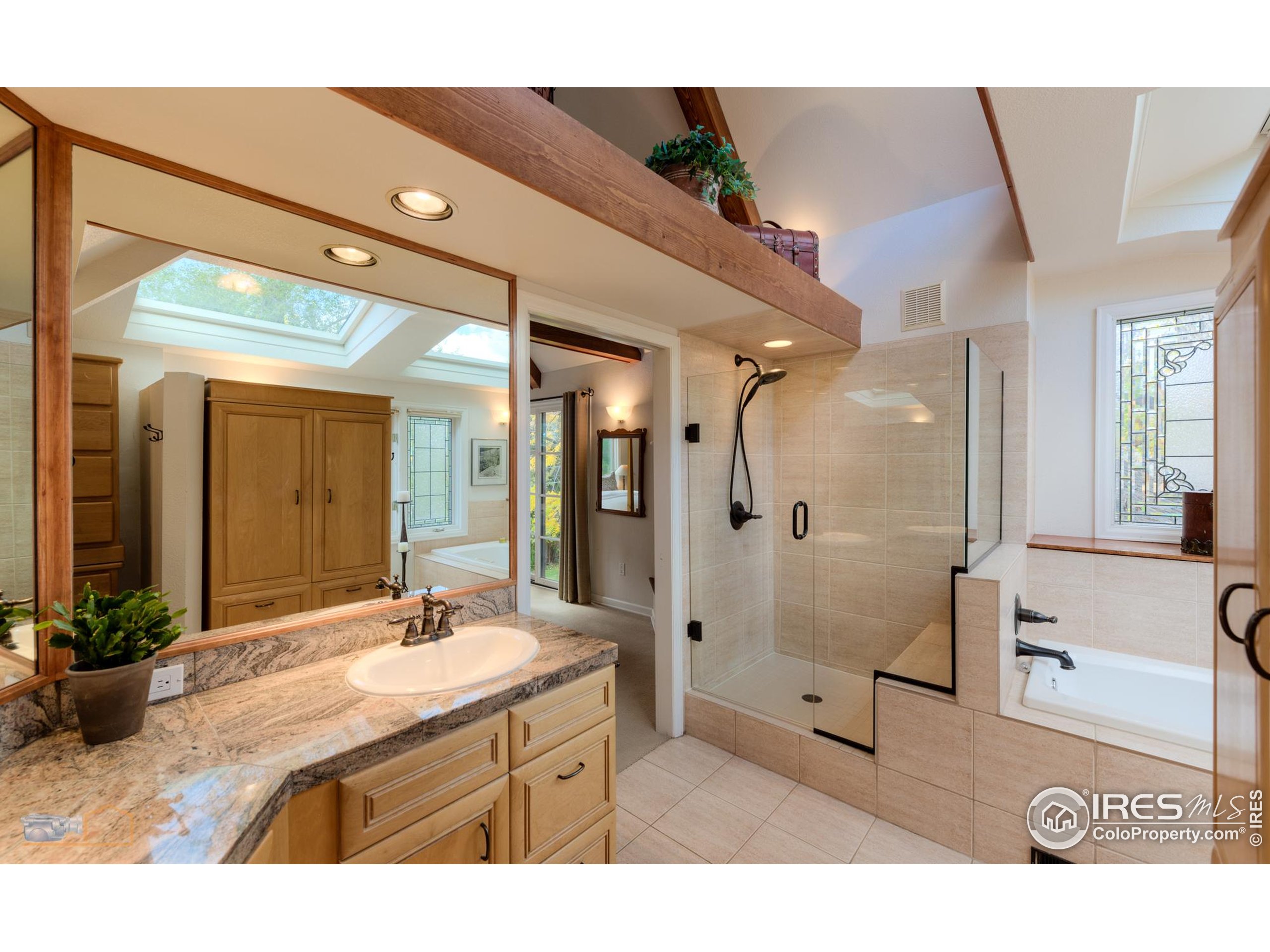 3737 26th Street Boulder, CO 80304 - Photo 14 of 47 a bathroom with a sink a large mirror and a shower