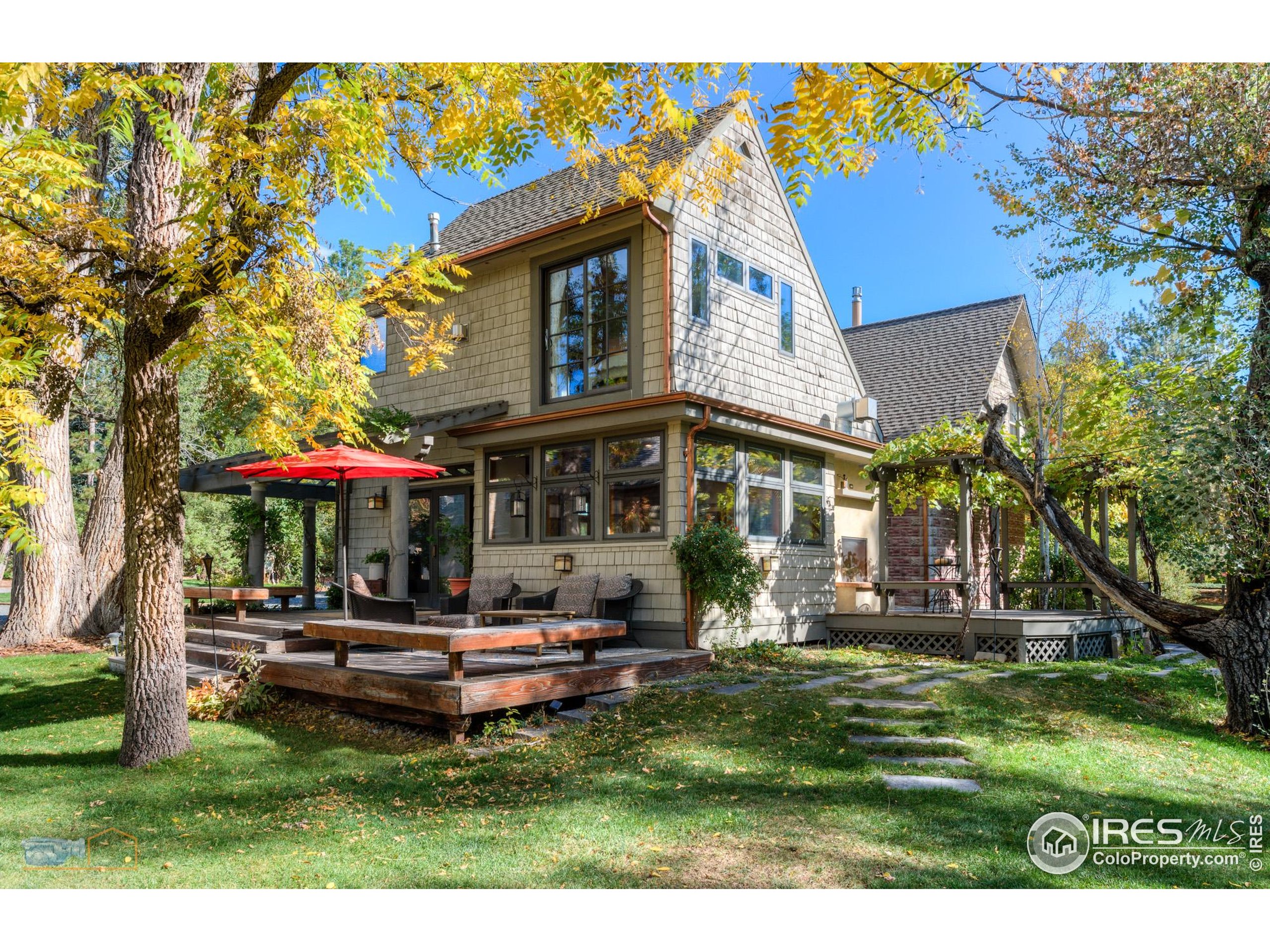 3737 26th Street Boulder, CO 80304 - Photo 29 of 47 a front view of a house with a yard table and chairs