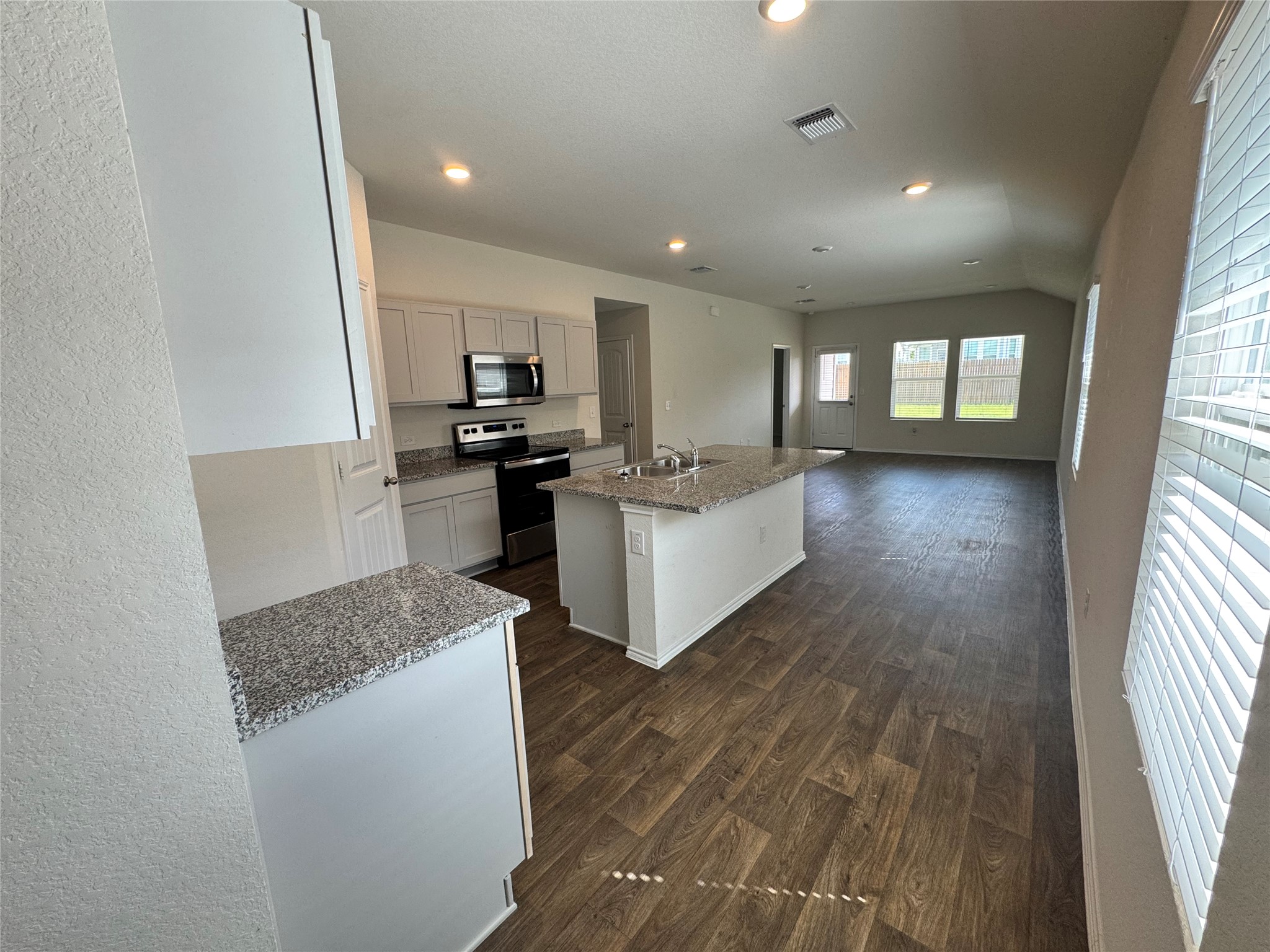 11820 Rush Lane Elgin, TX 78621 - Photo 24 of 31 An open concept design seamlessly connects the kitchen with the inviting living area.