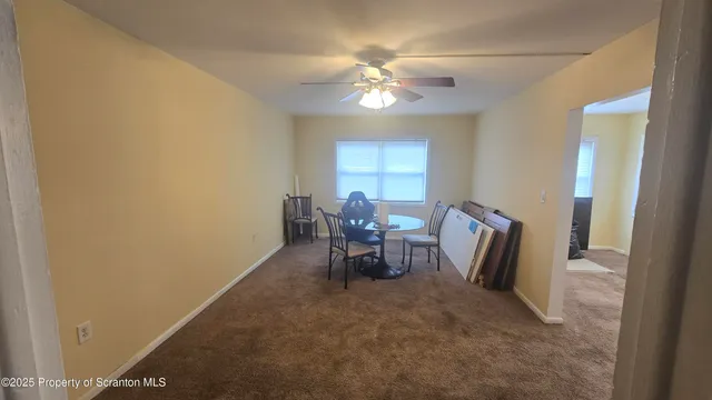 a view of a dining room with furniture and a chandelier