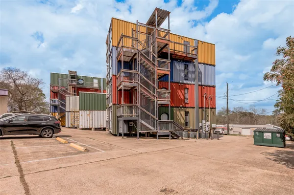 a view of a car is parked in front of a building