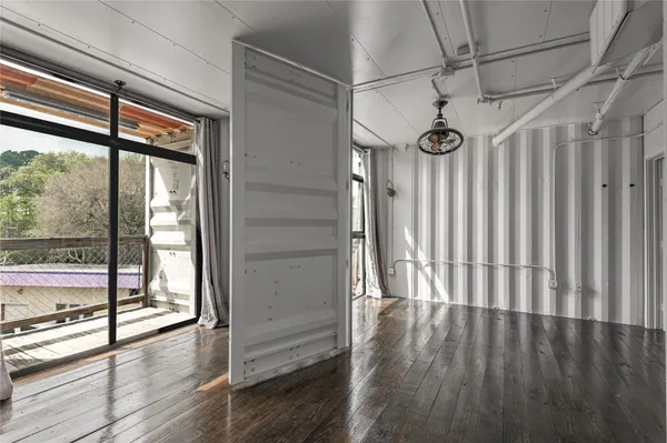 a view of a livingroom with wooden floor and furniture