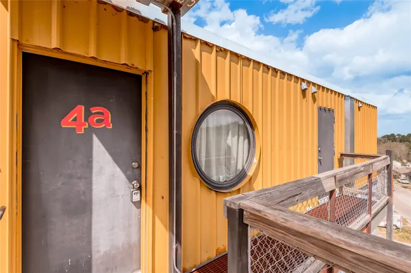 a hallway with wooden floor and door