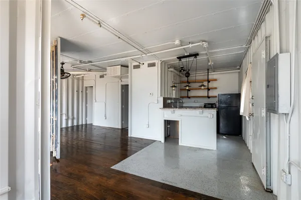 a kitchen with stainless steel appliances granite countertop a sink refrigerator and microwave