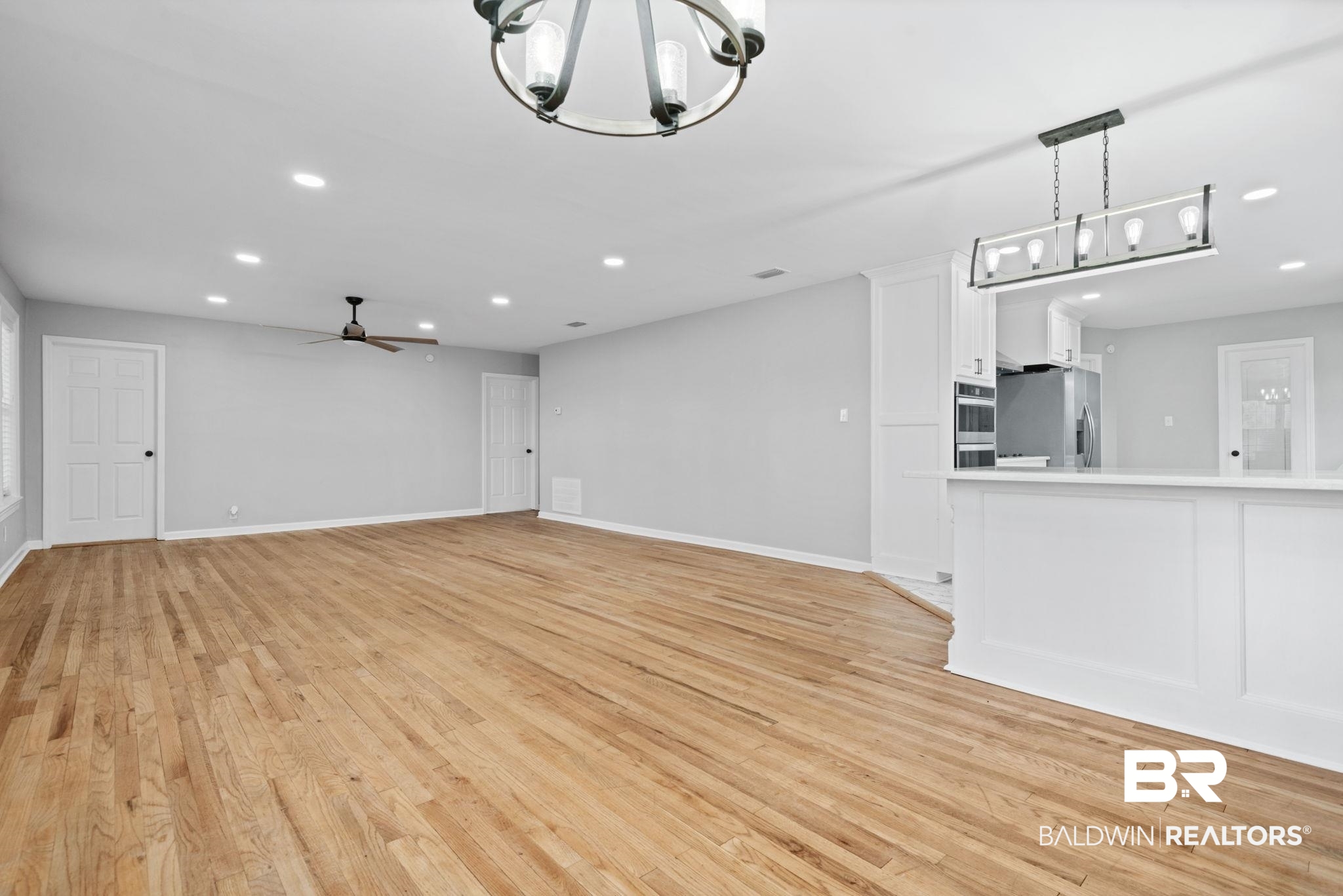 13461 Tom Gaston Road Mobile, AL 36695 - Photo 18 of 41 Unfurnished living room featuring recessed lighting, light wood-style flooring, a chandelier, and ceiling fan