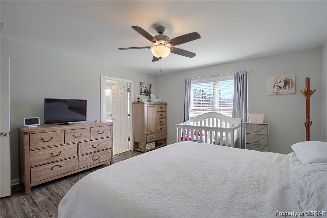 4944 Chestnut Fork Road Gloucester, VA 23061 - Photo 22 of 32 Bedroom with connected bathroom, dark wood-type flooring, and ceiling fan