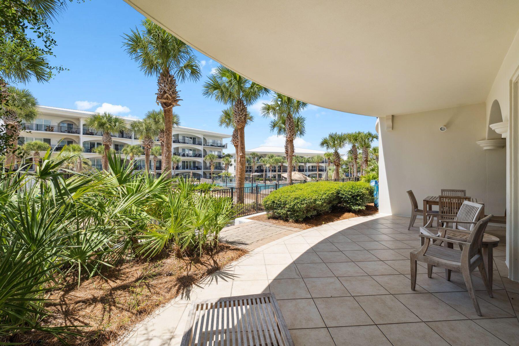 2421 West County Highway 30A, Unit D101 Santa Rosa Beach, FL 32459 - Photo 12 of 44 a view of a chairs and table in backyard