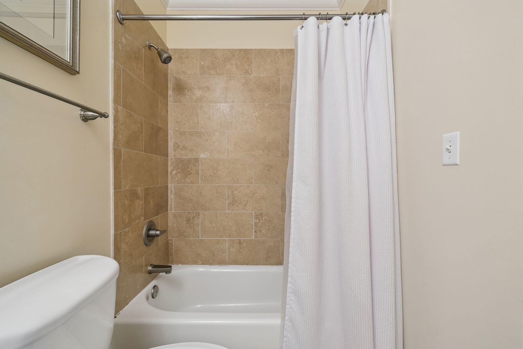 2421 West County Highway 30A, Unit D101 Santa Rosa Beach, FL 32459 - Photo 18 of 44 a bathroom with a shower curtain and a bathtub