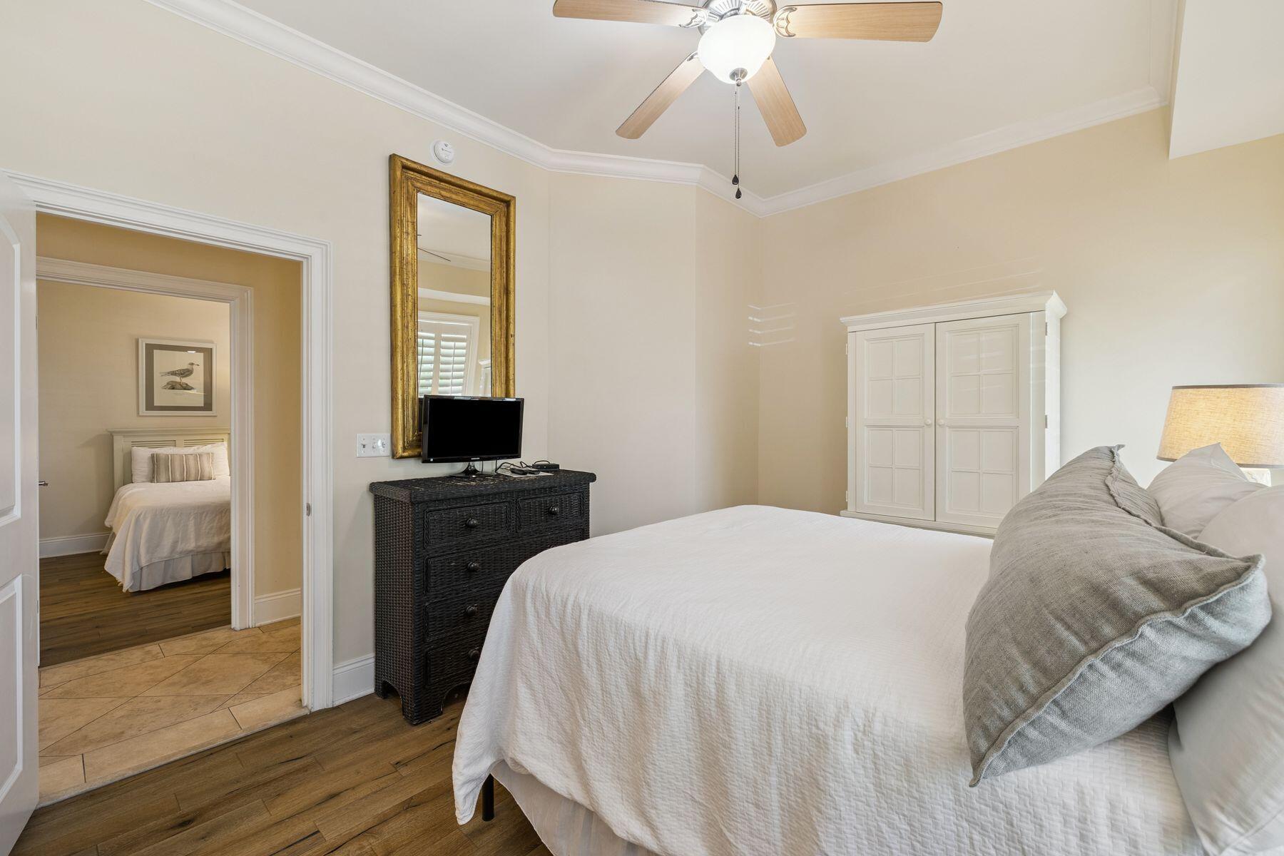 2421 West County Highway 30A, Unit D101 Santa Rosa Beach, FL 32459 - Photo 20 of 44 a bedroom with a bed and a chandelier