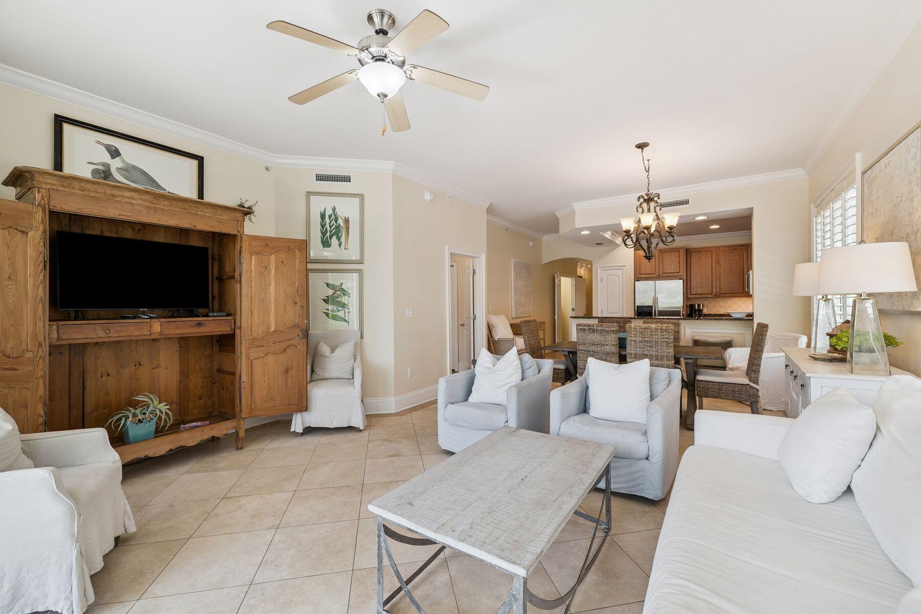 2421 West County Highway 30A, Unit D101 Santa Rosa Beach, FL 32459 - Photo 27 of 44 a living room with furniture a flat screen tv and kitchen view