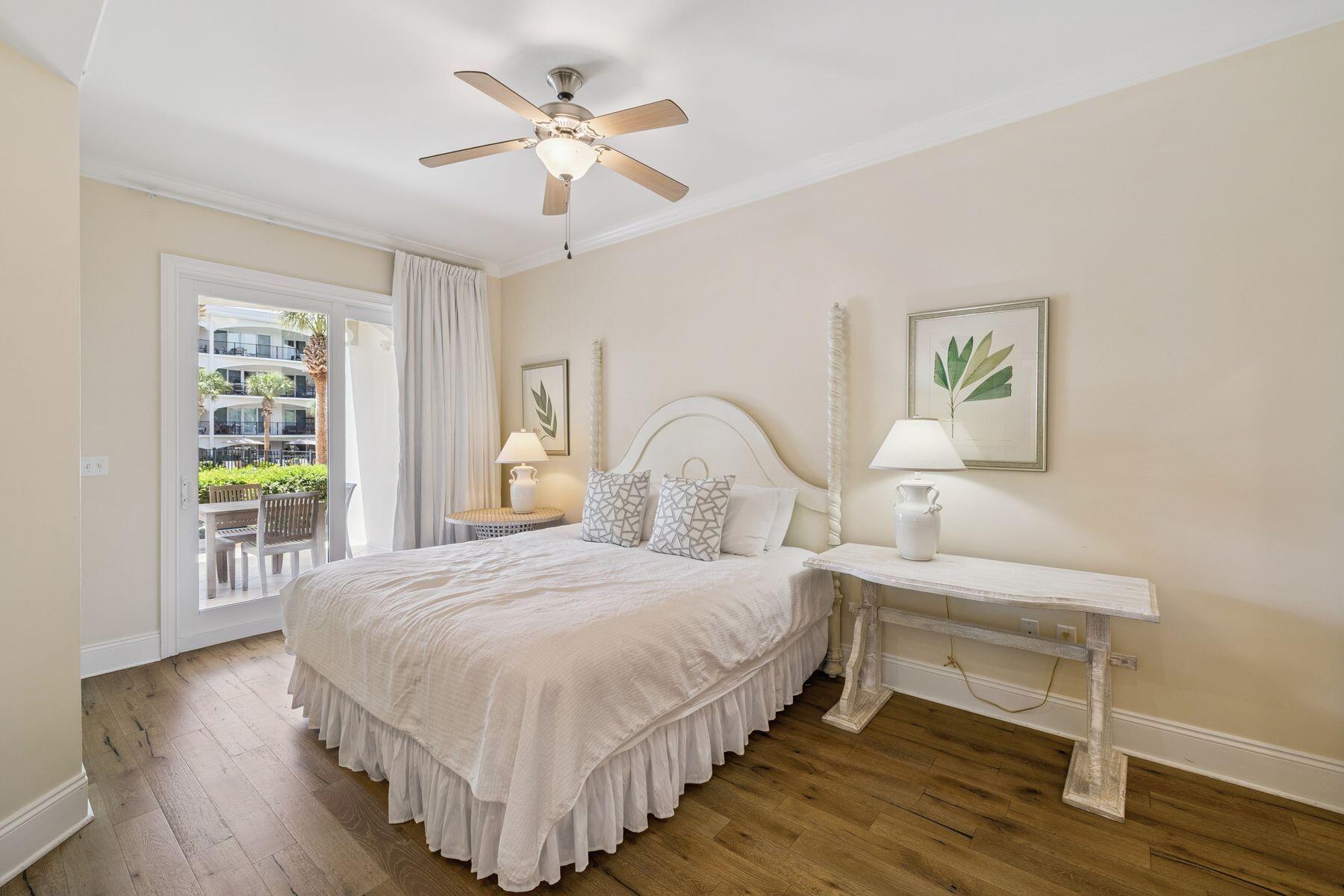 2421 West County Highway 30A, Unit D101 Santa Rosa Beach, FL 32459 - Photo 28 of 44 a bedroom with a bed chandelier and a window