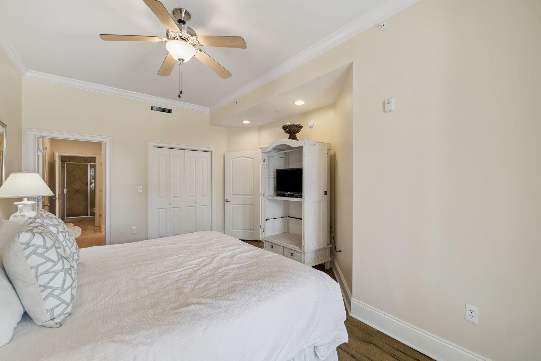 2421 West County Highway 30A, Unit D101 Santa Rosa Beach, FL 32459 - Photo 29 of 44 a bedroom with a large bed and a chandelier